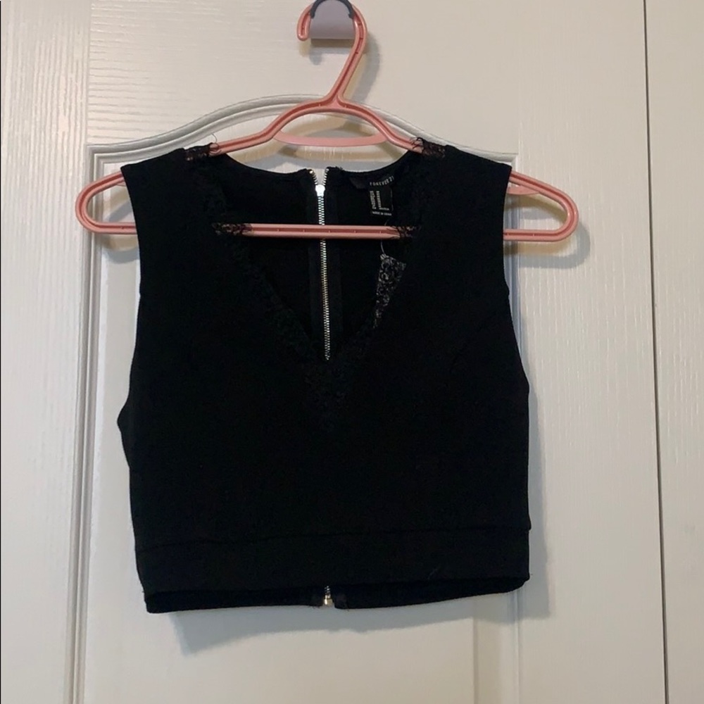 Black crop top with back zipper. Brand new w/ tag